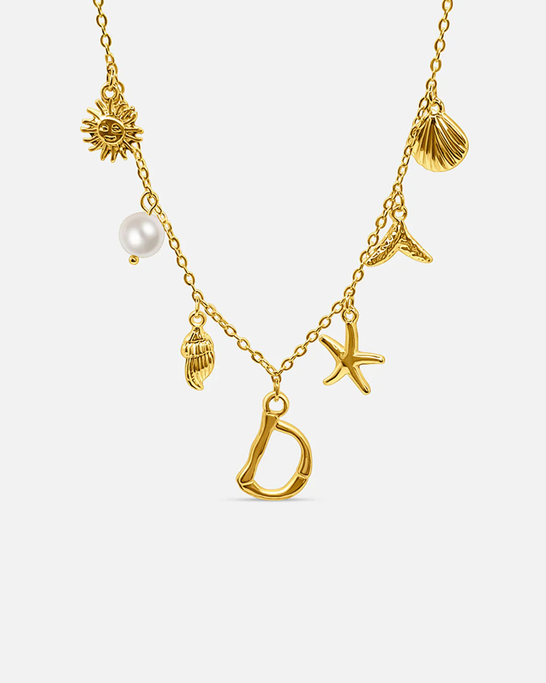 Gold necklace with various charms including a letter 'D', pearl, sun, shell, and starfish on a white background.