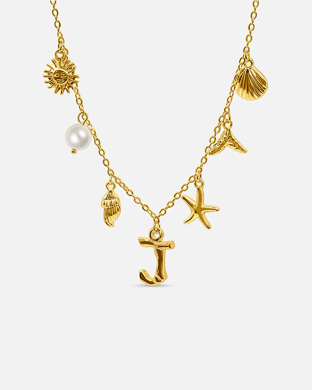 Gold necklace with various charms including a sun, shell, starfish, and pearl on a white background