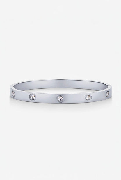 Silver bracelet with embedded stones on a white background
