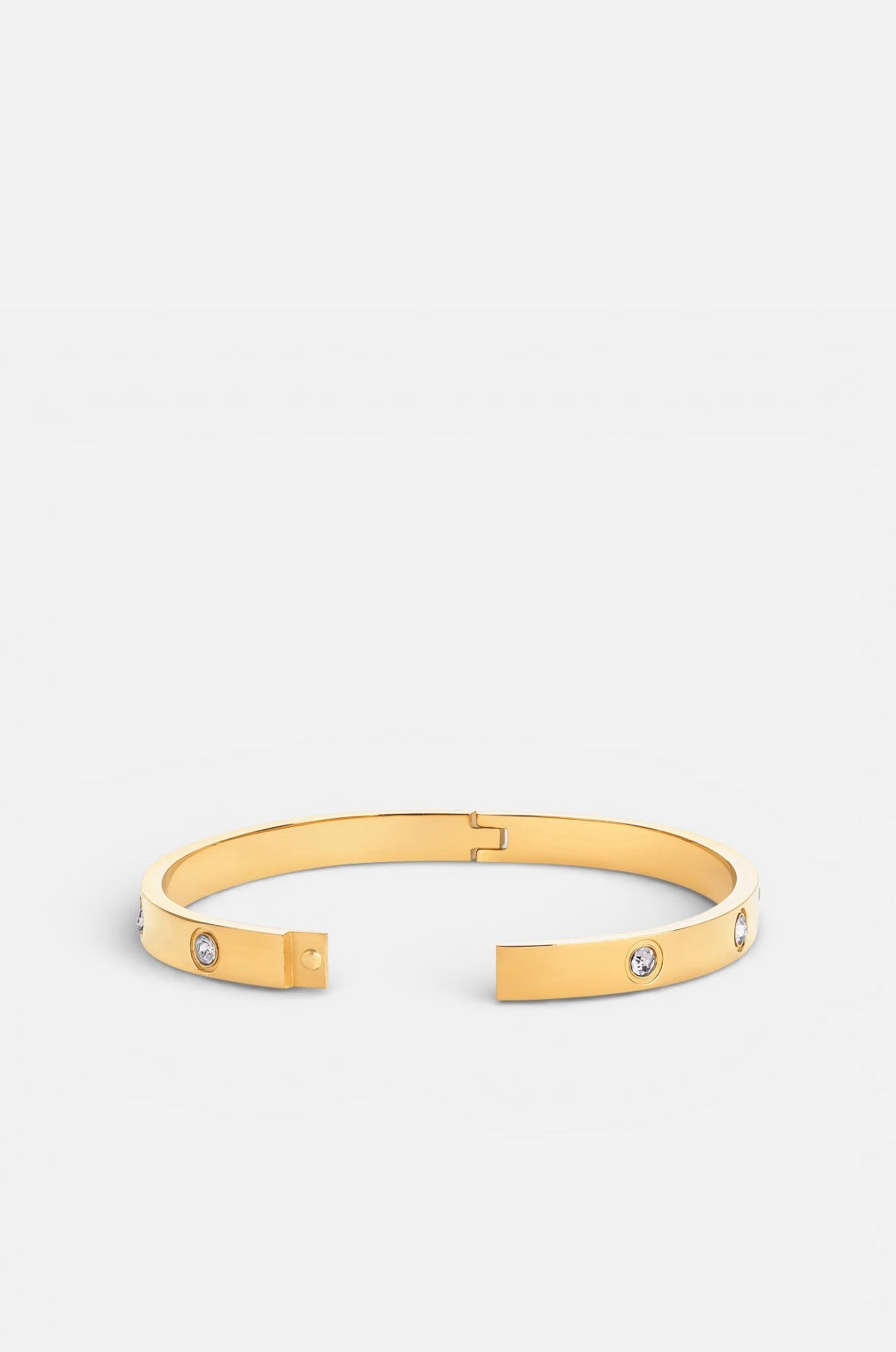 Gold bracelet with small stones on a white background