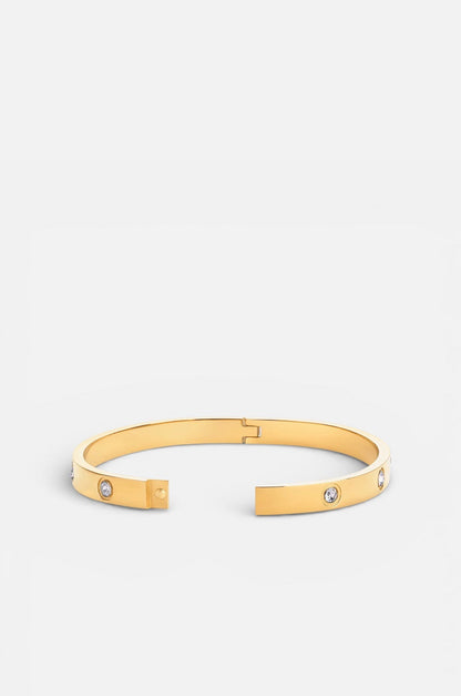Gold bracelet with small stones on a white background